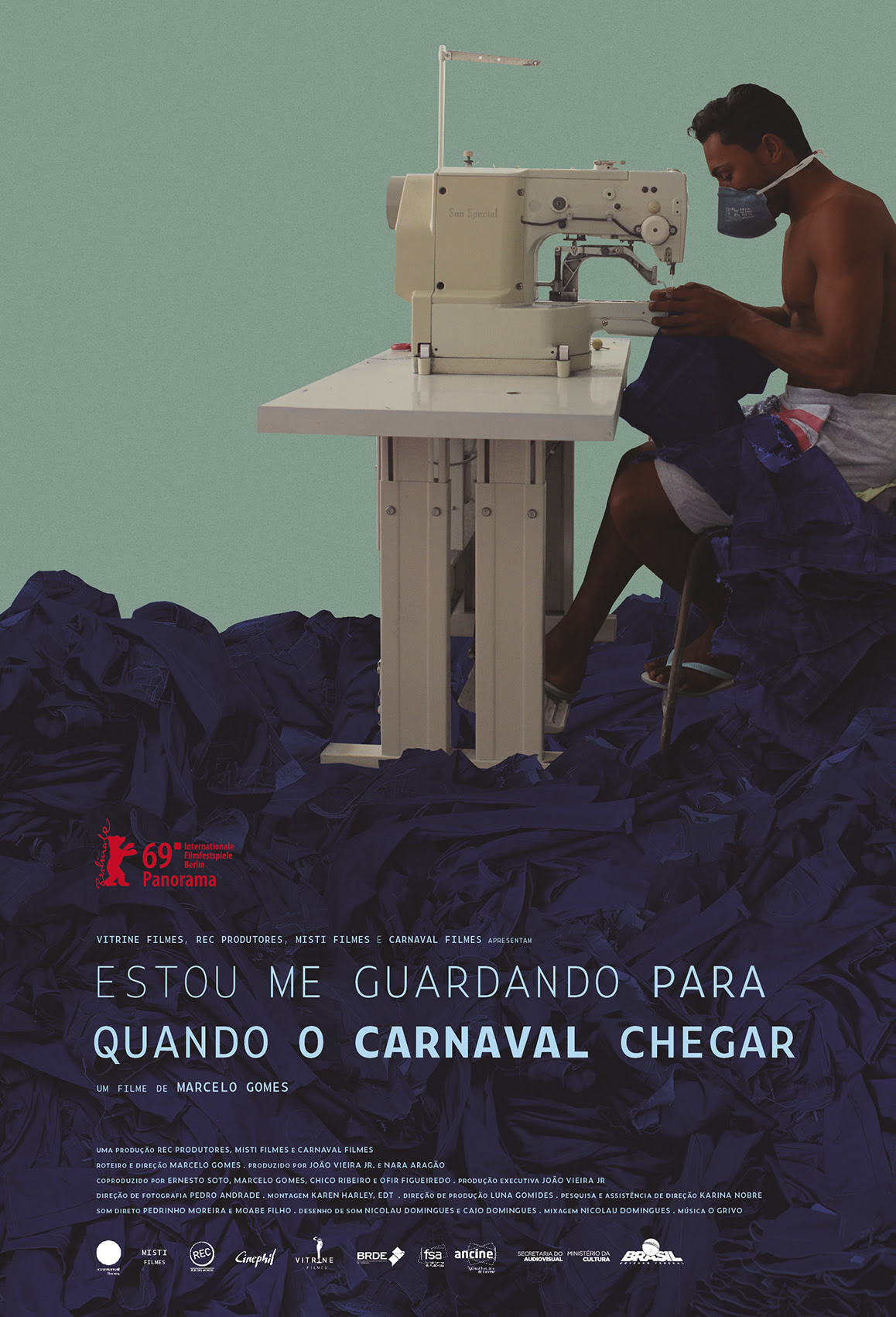 Cartaz do documentário Estou me Guardando para Quando o Carnaval Chegar, com a imagem de um homem utilizando uma máscara de proteção a covid-19 e uma máquina de costura. Está produzindo mais uma calça jeans em cima de diversas outras.